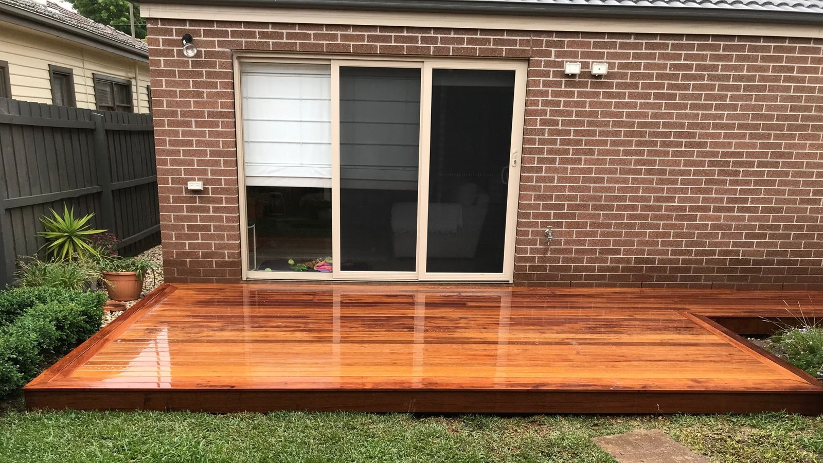 Freshly Stained Wooden Deck by Brick House - Expert Carpentry