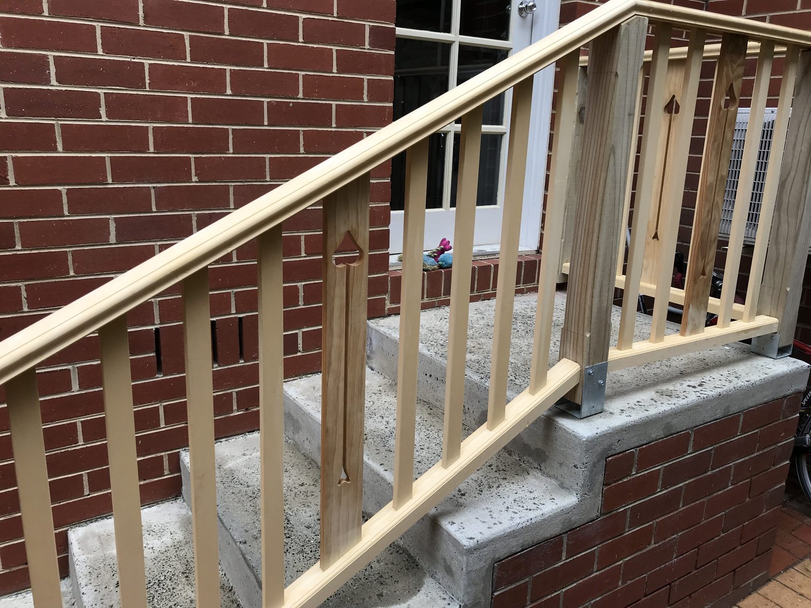 Custom wooden staircase with pine railing and balusters
