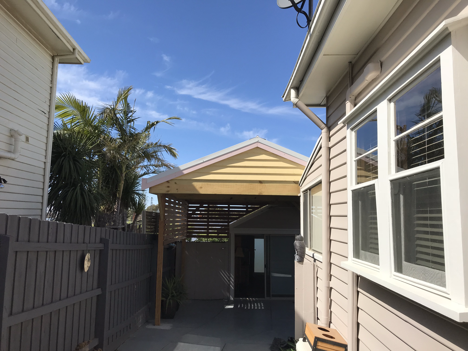 Modern residential carport construction with sunny outdoor area