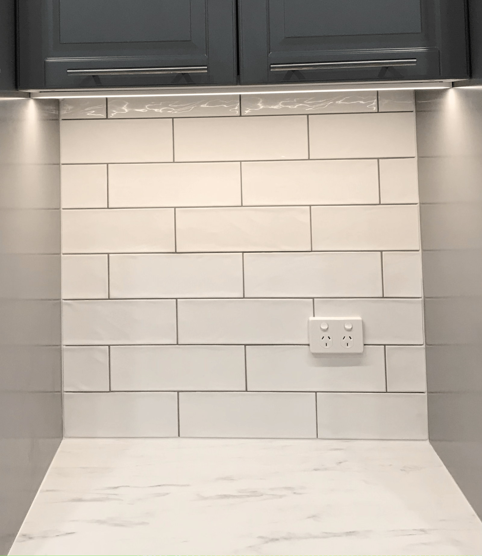 Modern kitchen tiling with white subway tiles and dark cabinets - Tiling Services